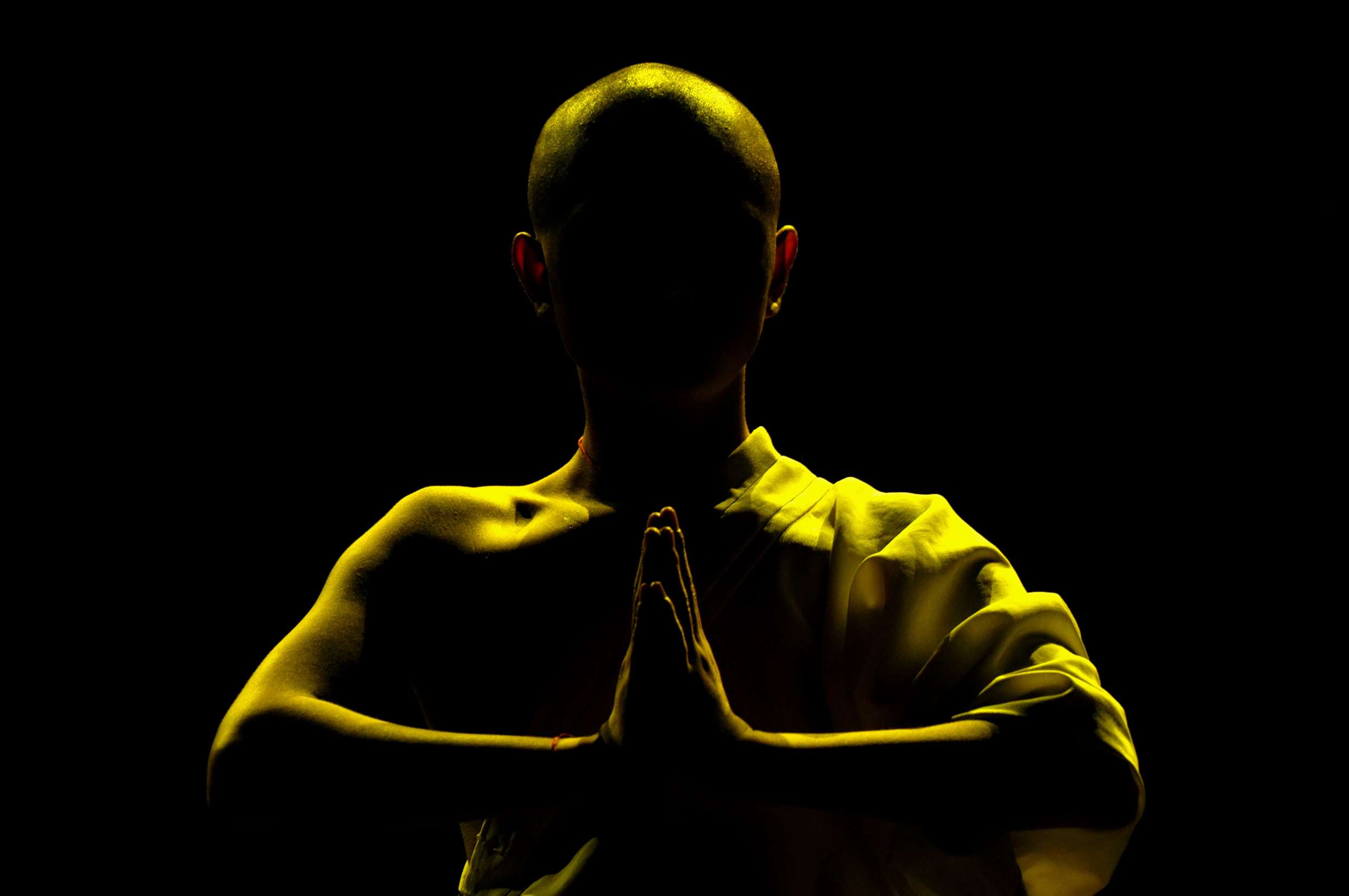 Shaolin monk in prayer pose, representing the Shaolin Temple liniment